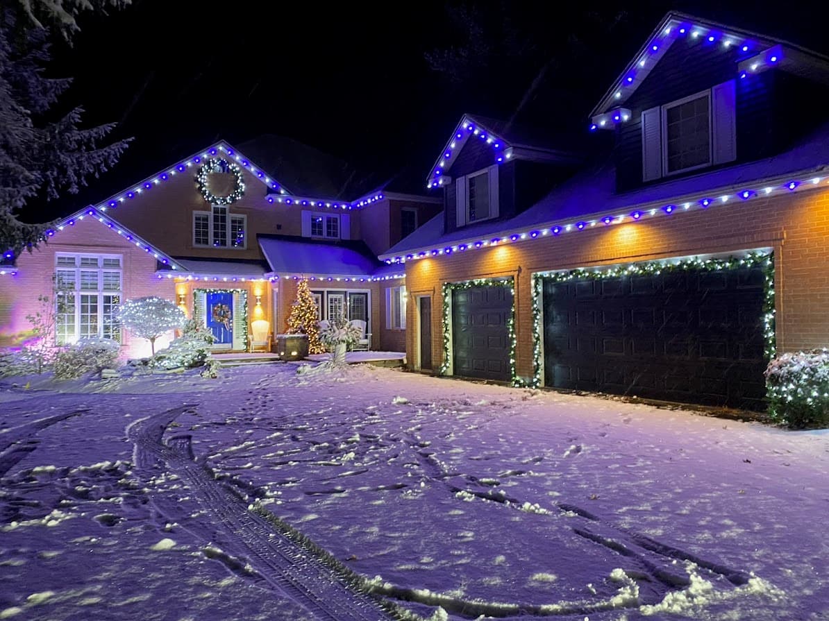 Professional Christmas light installation on a London Ontario home — full roofline LED lighting and decorated trees by We Install Christmas Lights